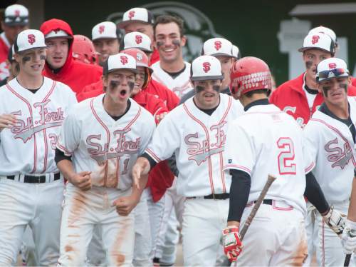 Rick Egan  |  The Salt Lake Tribune

Spanish Fork Dons celebrate after Nic Roberts (2) scored the go-ahead run in the 6th inning, as he scores on a double by Devin Argyle (15), in prep 4A baseball playoff action, Spanish Fork vs Maple Mountain, at Brent Brown field in Orem, Friday, May 22, 2015.