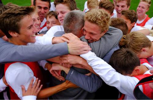 Francisco Kjolseth  |  The Salt Lake Tribune 
Alta coach Lee Mitchell is embraced by his team as they celebrate their 2-1 win over Brighton following the 5A boys' soccer championship game at Rio Tinto Stadium on Thursday, May 21, 2015.
