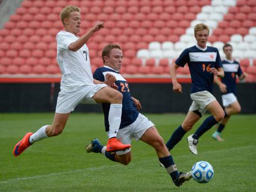 Francisco Kjolseth  |  The Salt Lake Tribune 
Alta's Gabe Aguilar, left,  goes airborne as he takes on  Spencer Campbell of  Brighton in game action during the 5A boys' soccer championship game at Rio Tinto Stadium on Thursday, May 21, 2015.