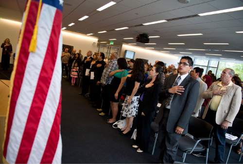 Lennie Mahler  |  The Salt Lake Tribune

100 immigrants from 40 countries say the Pledge of Allegiance during a naturalization ceremony to become U.S. citizens at the U.S. District Courthouse in downtown Salt Lake City, Friday, May 22, 2015.