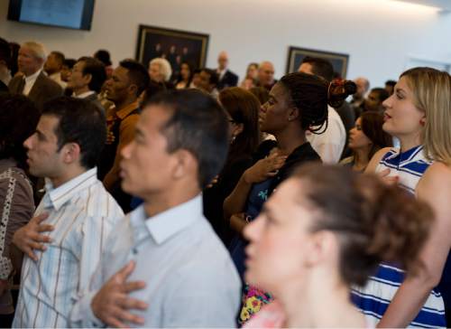 Lennie Mahler  |  The Salt Lake Tribune

100 immigrants from 40 countries say the Pledge of Allegiance during a naturalization ceremony to become U.S. citizens at the U.S. District Courthouse in downtown Salt Lake City, Friday, May 22, 2015.