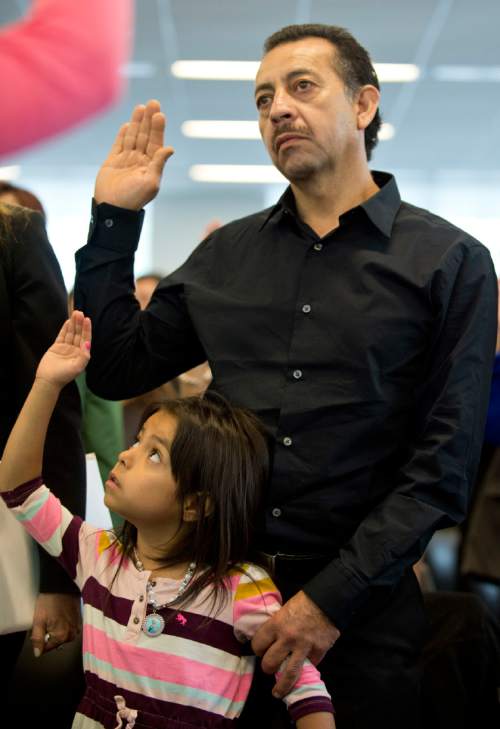 Lennie Mahler  |  The Salt Lake Tribune

Jose Luis Salazar, originally from Mexico, takes the Oath of Allegiance to become a U.S. citizen, accompanied by his granddaughter, Natalie. 100 immigrants from 40 countries became U.S. citizens at the U.S. District Courthouse in downtown Salt Lake City, Friday, May 22, 2015.