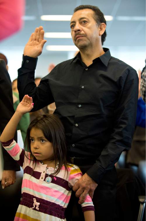 Lennie Mahler  |  The Salt Lake Tribune

Jose Luis Salazar, originally from Mexico, takes the Oath of Allegiance to become a U.S. citizen, accompanied by his granddaughter, Natalie. 100 immigrants from 40 countries became U.S. citizens at the U.S. District Courthouse in downtown Salt Lake City, Friday, May 22, 2015.