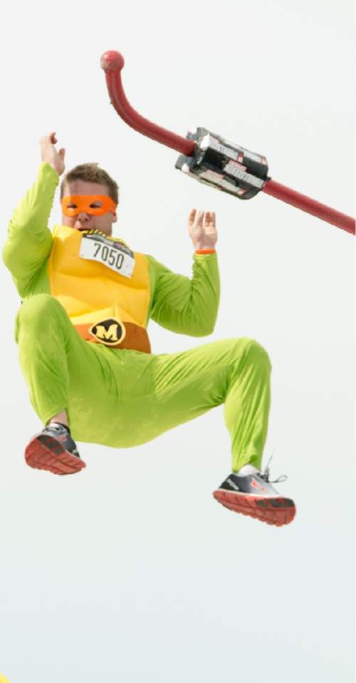 Rick Egan  |  The Salt Lake Tribune

A Ninja Turtle contestant competes in the pole vault, in the 5K ThrillSeeker Stunt Run, which incorporates zip lines, the world's largest inflatable water slide, a Tarzan-like swing, punching walls, at Hee Haw Farms in Pleasant Grove, Saturday, May 23, 2015.