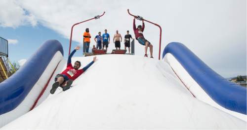 Rick Egan  |  The Salt Lake Tribune

Contestants compete in the pole vault at the 5K ThrillSeeker Stunt Run, which incorporates zip lines, the world's largest inflatable water slide, a Tarzan-like swing and punching walls, at Hee Haw Farms in Pleasant Grove, Saturday, May 23, 2015.