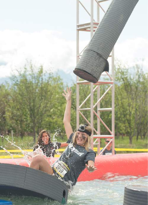 Rick Egan  |  The Salt Lake Tribune

Contestants try to not to get wet in the swinger's island obstacle at the 5K ThrillSeeker Stunt Run. The run incorporates zip lines, the world's largest inflatable water slide, a Tarzan-like swing, punching walls, at Hee Haw Farms in Pleasant Grove, Saturday, May 23, 2015.