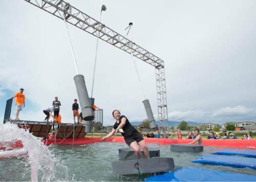 Rick Egan  |  The Salt Lake Tribune

Contestants try to not to get wet in the swinger's island obstacle at the 5K ThrillSeeker Stunt Run, which incorporates zip lines, the world's largest inflatable water slide, a Tarzan-like swing and punching walls, at Hee Haw Farms in Pleasant Grove, Saturday, May 23, 2015.