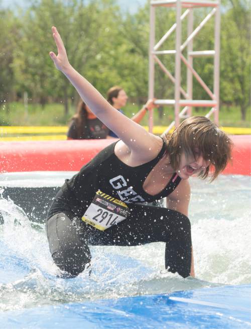 Rick Egan  |  The Salt Lake Tribune

Contestants try to not to get wet in the swinger's island obstacle at the 5K ThrillSeeker Stunt Run, which incorporates zip lines, the world's largest inflatable water slide, a Tarzan-like swing and punching walls, at Hee Haw Farms in Pleasant Grove, Saturday, May 23, 2015.