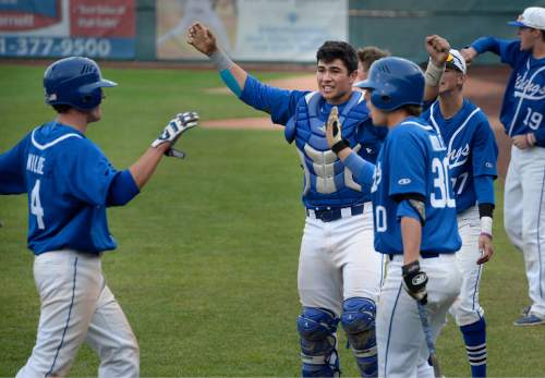 Scott Sommerdorf   |  The Salt Lake Tribune
Payton Henry, and the rest of the Vikings greet Matthew Wilde after he scored during the Vikings' 4-run rally in the 5th inning. Pleasant Grove defeated Bingham 6-2 to win the Utah 5A title, Thursday, May 21, 2015.