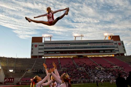 Chris Detrick  |  The Salt Lake Tribune
East High senior cheerleader Sammie Tidwell completes a toe touch basket toss during the East vs Olympus football game at Rice-Eccles Stadium Thursday November 14, 2013. East won the game 47-21.
