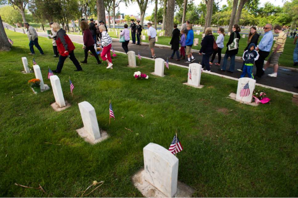 Steve Griffin  |  The Salt Lake Tribune
People walk through the cemetery as Fort Douglas hosts its annual Memorial Day observance at the cemetery in Salt Lake City, Monday, May 25, 2015.