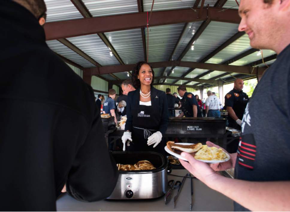 Steve Griffin  |  The Salt Lake Tribune
Rep. Mia Love, R-Utah joins Herriman city employees as they cook up hash browns, eggs, sausage and pancakes as they host their annual Memorial Day chuck-wagon breakfast at the Herriman City Park on Monday, May 25, 2015.