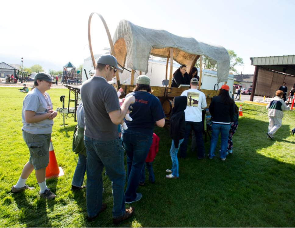 Steve Griffin  |  The Salt Lake Tribune
People line up at the covered wagon to get tickets to the Memorial Day chuck- wagon breakfast at the Herriman City Park on Monday, May 25, 2015.