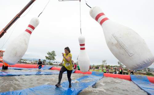 Rick Egan  |  The Salt Lake Tribune

Sarah Mathew avoids falling in the water as she out-runs the giant bowling pins in the Jugglernaught obstacle in the 5K ThrillSeeker Stunt Run. The run incorporates zip lines, the world's largest inflatable water slide, a Tarzan-like swing and punching walls, at Hee Haw Farms in Pleasant Grove, Saturday, May 23, 2015.