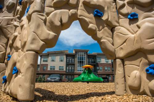 Chris Detrick  |  The Salt Lake Tribune
The playground and exterior of housing units at Canyon Crossing at Riverwalk Wednesday May 27, 2015.  Canyon Crossing at Riverwalk is a newly constructed 10-building affordable housing community in Midvale. 
The $36 million development creates 180 apartments for low-income families in the area and was made possible through a $13 million Low-Income Housing Tax Credit investment by American Express syndicated by Enterprise Community Investment.