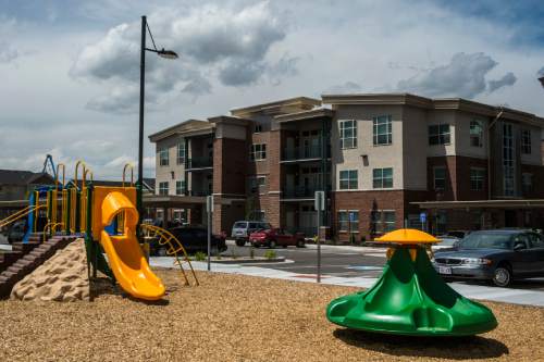 Chris Detrick  |  The Salt Lake Tribune
The playground and exterior of housing units at Canyon Crossing at Riverwalk Wednesday May 27, 2015.  Canyon Crossing at Riverwalk is a newly constructed 10-building affordable housing community in Midvale. 
The $36 million development creates 180 apartments for low-income families in the area and was made possible through a $13 million Low-Income Housing Tax Credit investment by American Express syndicated by Enterprise Community Investment.