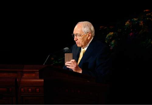 Scott Sommerdorf   |  The Salt Lake Tribune
Elder L. Tom Perry holds up a small book of guidelines for LDS servicemen as he spoke during the second day of the 183rd LDS General Conference, Sunday, April 7, 2013.