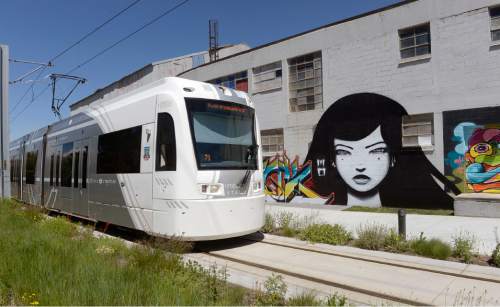 Al Hartmann |  The Salt Lake Tribune
UTA S-Line streetcar passes by warehouse painted with unusual art.  The S-Line runs about every twenty minutes from Fairmont Park in Sugarhouse to downtown business section of South Salt Lake at 200 West.