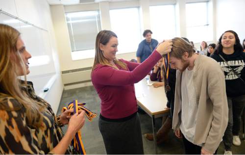 Francisco Kjolseth  |  The Salt Lake Tribune 
Mindi Holmdahl, center, principal of Horizonte Instruction and Training Center, presents Chase Skuppin with a medal presented to all the students receiving scholarships who were about to graduate. The students were attending a college-prep class to learn about resources available to them as they navigate college.