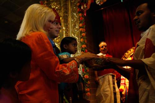Chris Detrick |  Tribune file photo
Priest Satish Kumar of the Sri Ganesha Hindu Temple of Utah blesses Gov. Jon Huntsman Jr., First Lady Mary Kaye, Asha and Gracie Mei Huntsman during a celebration in 2008.
