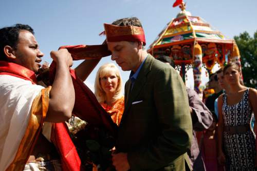 Chris Detrick |  Tribune file photo
Priest Satish Kumar of the Sri Ganesha Hindu Temple of Utah welcomes Gov. Gov. Jon Huntsman Jr. with a traditional silken turban while First Lady Mary Kaye Huntsman looks on in 2008.