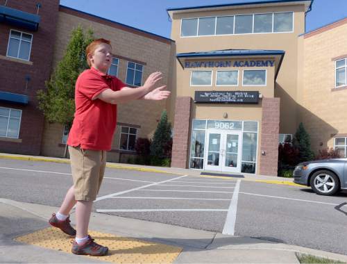 Al Hartmann |  The Salt Lake Tribune
Fifth-grader Brad Mason describes how he blocked a first-grader with his arms and flag to keep her from running in front of a car at the Hawthorn Academy school entrance. He was given the highest award available to a AAA School Safety Patroller, the Lifesaving Medal.