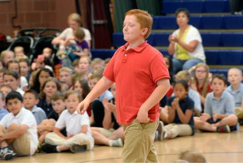 Al Hartmann |  The Salt Lake Tribune
Fifth-grader Brad Mason walks to the front of the auditorium at Hawthorn Academy in West Jordan Monday June 2, 2015, to accept the highest award given to a AAA School Safety Patroller, the Lifesaving Medal.