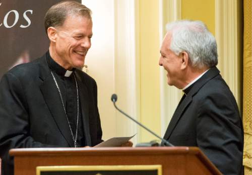 Rick Egan  |  The Salt Lake Tribune

Archbishop John C. Wester  shakes hands with the Rev. Martin Diaz, pastor of the Cathedral of the Madeleine, at a reception at the Little America on Sunday, May 31, 2015.