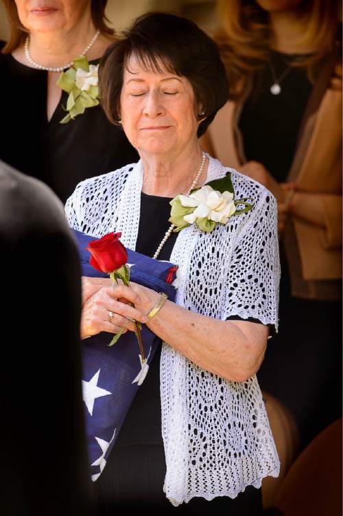 Trent Nelson  |  The Salt Lake Tribune
Barbara Perry, wife of LDS apostle L. Tom Perry, embraces a flag given to her by a Marine Corps Honor Guard at the graveside service for her husband,  Friday June 5, 2015 at the Salt Lake City Cemetery.