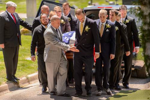 Trent Nelson  |  The Salt Lake Tribune
Pallbearers carry the casket at the graveside service for the late LDS apostle L. Tom Perry,  Friday June 5, 2015 at the Salt Lake City Cemetery.