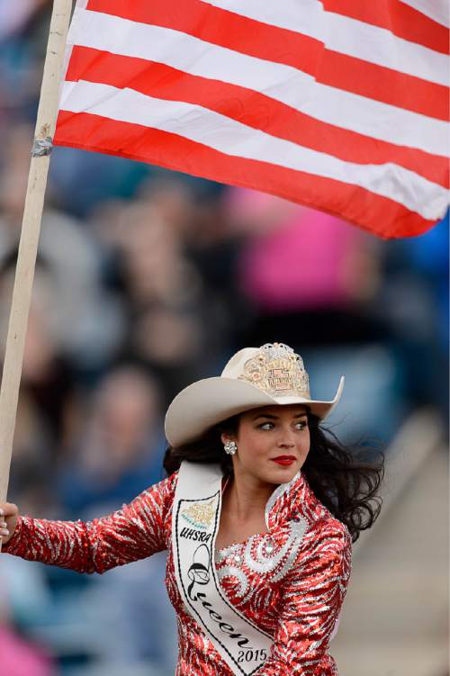 Trent Nelson  |  The Salt Lake Tribune
Utah High School Rodeo Queen Baylee LaFleur rides in with the flag at the Utah High School Rodeo Association state championships in Heber, Saturday June 6, 2015.