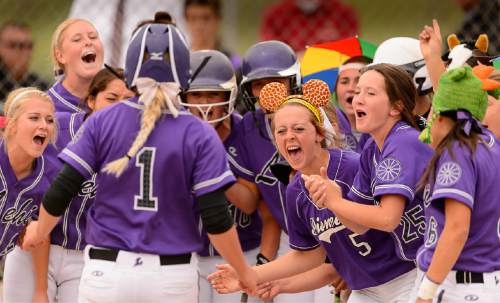 Trent Nelson  |  The Salt Lake Tribune
Lehi's Stephani Zimmerman is met at home after hitting a home run as Herriman faces Lehi in the 5A high school softball championship game, in West Valley City, Friday May 22, 2015.