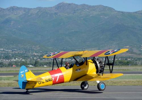 Al Hartmann |  The Salt Lake Tribune
A restored World War II-era Steerman Navy training plane takes off at the Heber City Airport Tuesday, June 8, 2015. Several restored vintage World War II planes are on display, including a B-17 Flying Fortress called Sentimental Journey. Sentimental Journey is giving tours and rides for a fee through Sunday.