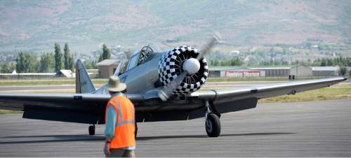 Al Hartmann |  The Salt Lake Tribune
A restored  World War II-era T-6 Texan Navy-Air Force training plane taxis in after a flight at the Heber City Airport Tuesday, June 8, 2015.  Several restored vintage World War II planes are on display including a B-17 Flying Fortress called Sentimental Journey. It is giving tours and rides for a fee through Sunday.