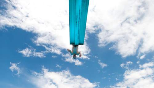 Steve Griffin  |  The Salt Lake Tribune

Cody Peterson, of Springville, does a front flip from the high dive at the Taylorsville Recreation Center on Tuesday, June 9, 2015. Salt Lake County Health Department (SLCoHD) held its annual Healthy Swim Season media day to remind residents to practice healthy swimming behaviors and dispel a few pool myths.