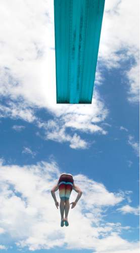 Steve Griffin  |  The Salt Lake Tribune

Cody Peterson, of Springville, does a front flip from the high dive at the Taylorsville Recreation Center Tuesday, June 9, 2015. Salt Lake County Health Department (SLCoHD) held its annual Healthy Swim Season media day to remind residents to practice healthy swimming behaviors and dispel a few pool myths.