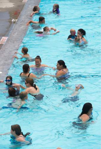 Steve Griffin  |  The Salt Lake Tribune

Residents enjoy the Taylorsville Recreation Center swimming pool Tuesday, June 9, 2015. Salt Lake County Health Department (SLCoHD) held its annual Healthy Swim Season media day to remind residents to practice healthy swimming behaviors and dispel a few pool myths.