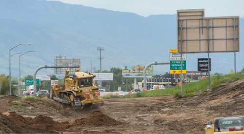 Francisco Kjolseth  |  The Salt Lake Tribune
UDOT begins construction of a new interchange at I-15 and Hill Field Road, with a funky ThrU Turn intersection in Layton, as crews clear space next to the freeway for the construction of new bridges as well. Traffic is so heavy in the area now that it takes about 10 minutes to travel a half-mile from Main Street to Layton Hills Mall, with cars often backing onto the freeway.