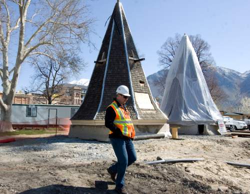 Kim Raff  |  The Salt Lake Tribune

A worker walks past a spire that will be used on the construction of the Provo City Center Temple at the construction site in Provo on Thursday. The temple is being rebuilt after a fire in 2010.