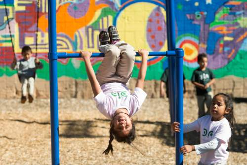 Rick Egan  |  The Salt Lake Tribune

Marely Bahena (left) and Sheyla Alacon, play on the playground at Salt Lake's Dual Immersion Academy, Friday, October 3, 2014