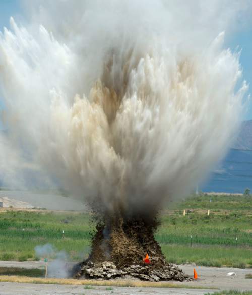 Steve Griffin  |  The Salt Lake Tribune
Dirt and water fly into the air as an explosive device is detonated by ATF agents during an explosive safety training exercise open to the media at the Salt Lake Airport Police Training Center in Salt Lake City, Thursday, June 11, 2015.