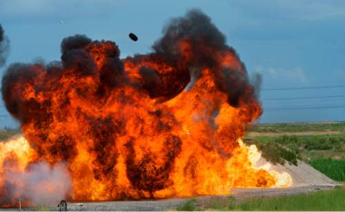 Steve Griffin  |  The Salt Lake Tribune


A car tire is launched into the air as explosive devices ignite in sequence as they are detonated by ATF agents during an explosive safety training exercise open to the media at the Salt Lake Airport Police Training Center in Salt Lake City, Thursday, June 11, 2015.