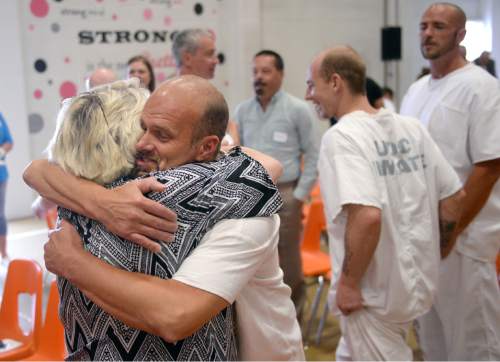 Al Hartmann |  The Salt Lake Tribune
Utah State Prison inmate James Charles get a hug of congratulations from his sister, Clara Susan, after graduating from South Park Academy Wednesday June 10, 2015. Family members got to spend some time together with inmates after the formal ceremony ended and they had changed back into their prison uniforms. About 150 men and women serving time at the prison received diplomas at the ceremony.