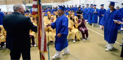 Al Hartmann |  The Salt Lake Tribune
Utah State Prison inmates at South Park Academy receive their diplomas in a graduation commencement ceremony Wednesday June 10, 2015. About 150 men and women serving time at the prison received high school diplomas during the ceremony.