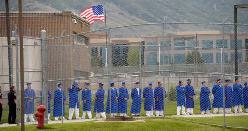 Al Hartmann |  The Salt Lake Tribune
Male inmates at the Utah State Prison in Draper line up behind a fence before walking to the auditiorium for a graduation commencement ceremony from South Park Academy.  About 150 men and women serving time at the prison received high school diplomas during the ceremony on Wednesday June 10, 2015.