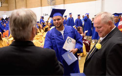Al Hartmann |  The Salt Lake Tribune
Utah State Prison inmate Nathaniel Ganier, who was recognized as one of the "Students of the Year" from South Park Academy, receives his diploma in a graduation commencement ceremony Wednesday June 10, 2015. He was among about 150 men and women serving time at the prison received diplomas at the ceremony.
