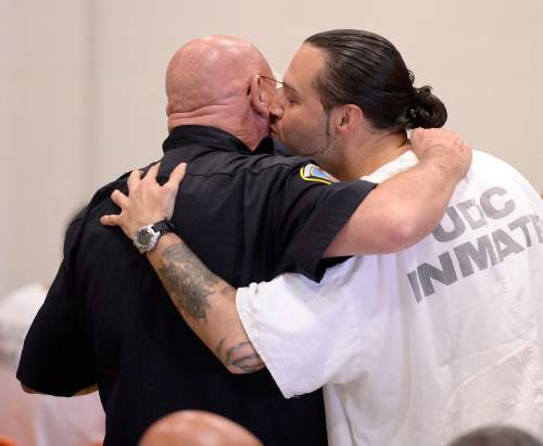 Al Hartmann |  The Salt Lake Tribune
Utah State Prison inmate David Ricks leans in and gives Capt. Ron Wilson a peck on the cheek after he received his high school diploma from South Park Academy Wednesday June 10, 2015. Wilson is in charge of security in his section. "No joke! The captain is a good guy with a big heart,"  Ricks said. Wilson said that Ricks has "come a long way."