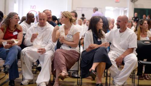 Al Hartmann |  The Salt Lake Tribune
Family members spend some time together with Utah State Prison inmates who had just graduated from South Park Academy Wednesday June 10, 2015. About 150 men and women serving time at the prison received diplomas at the ceremony.