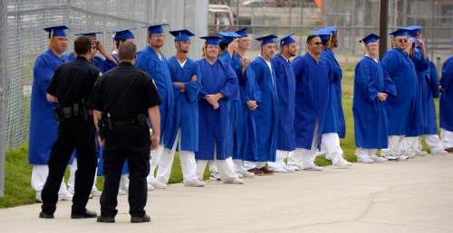 Al Hartmann |  The Salt Lake Tribune
Male inmates at the Utah State Prison in Draper line up along a fence before walking to the auditiorium for a graduation commencement ceremony from South Park Academy. About 150 men and women serving time at the prison received diplomas at the ceremony on Wednesday June 10, 2015.