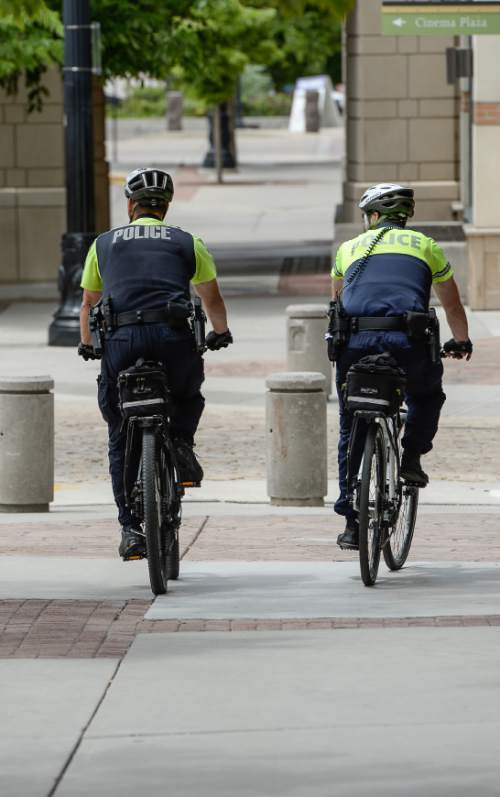 Francisco Kjolseth  |  The Salt Lake Tribune
Salt Lake City police officers Bryce Curdie and Slade Bailey patrol the streets near The Gateway on Wednesday, June 10, 2015. The City Council will spend more money on bicycle cops in the first part of the coming fiscal year. The council has budgeted $1.1 million for eight bike patrol officers and eight social workers. The mayor's proposed $254 million budget starts July 1. The new bike patrols are expected in September.